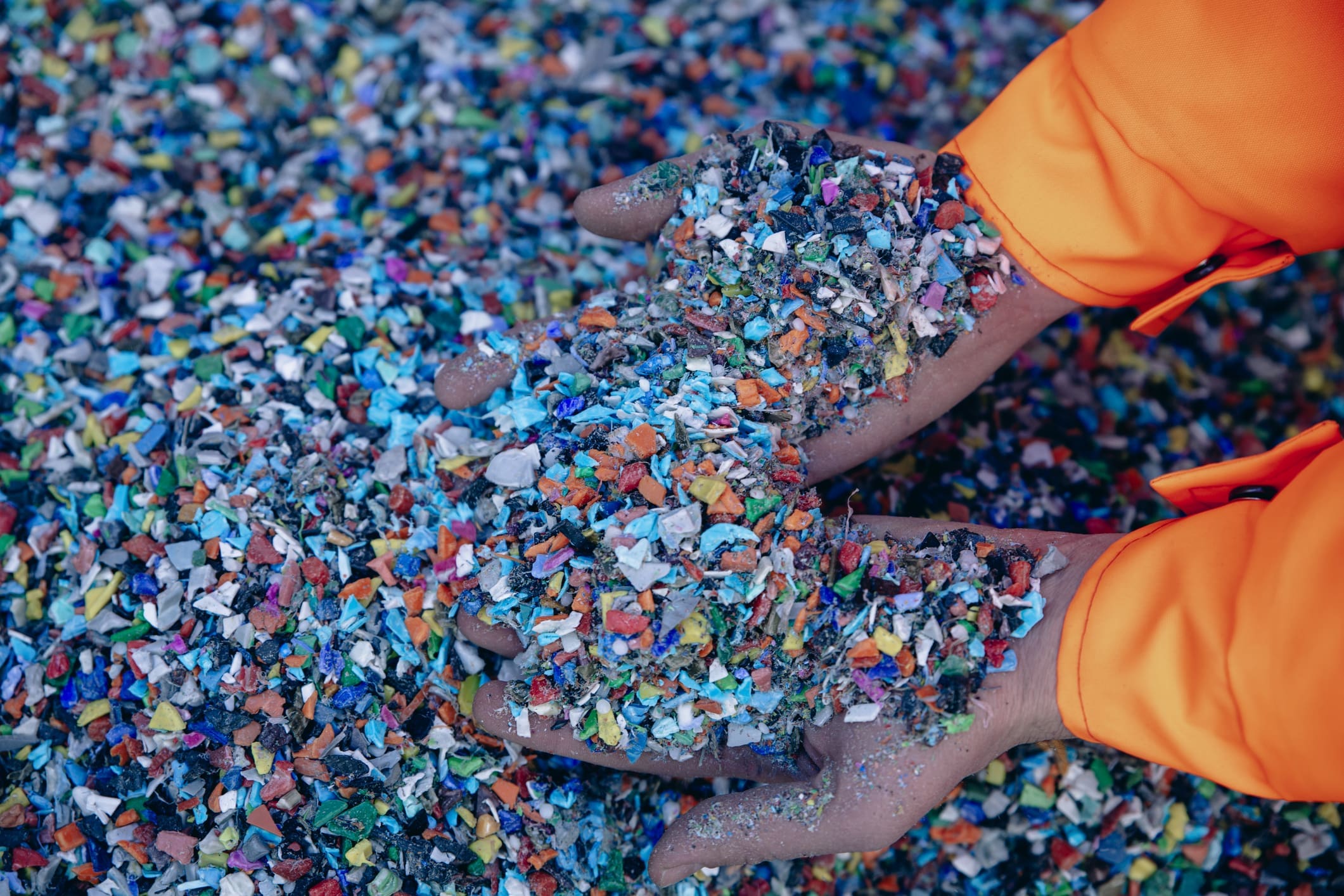 Plastic Resin pellets in holding hands.